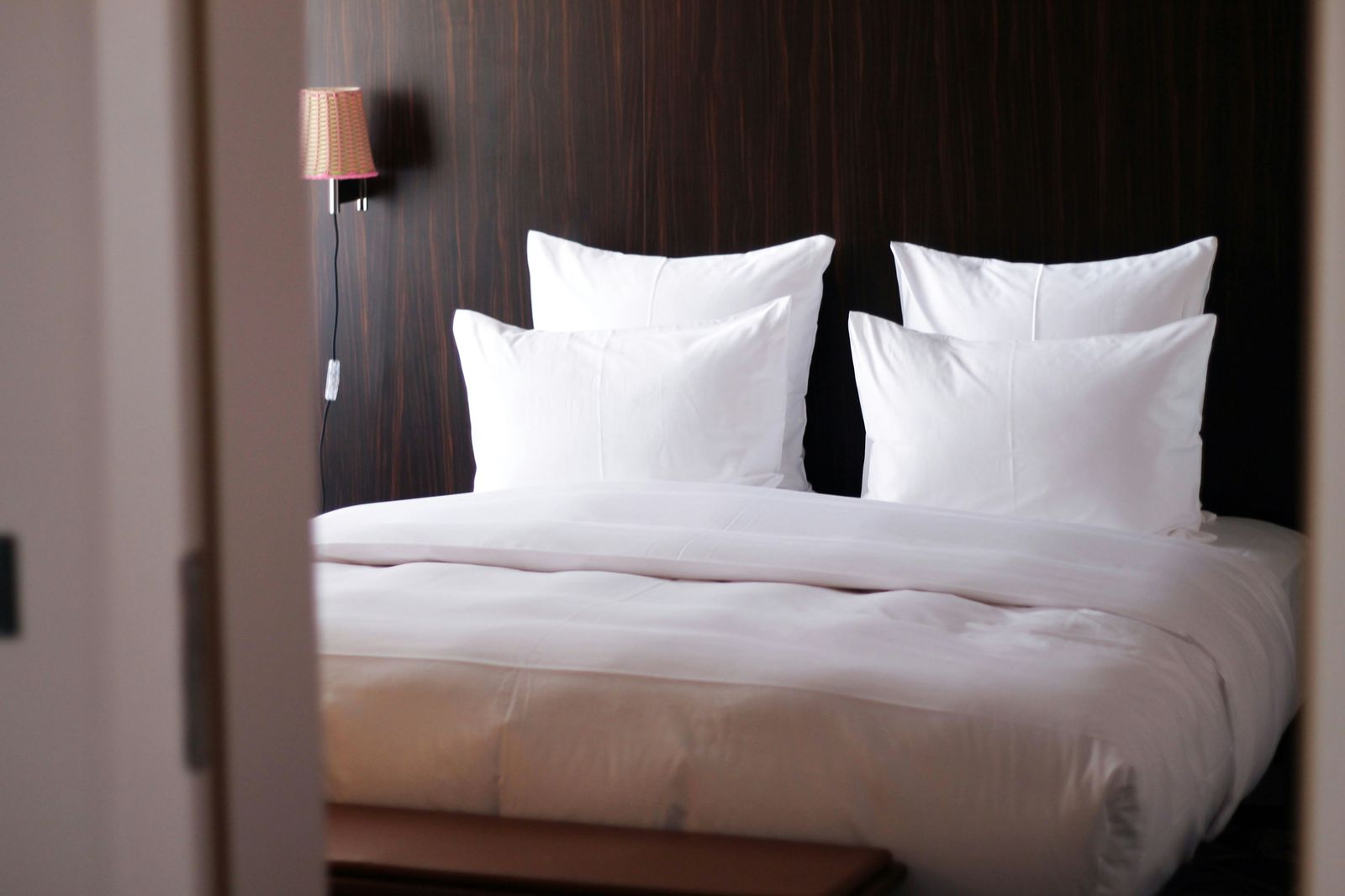 Bed made with white hotel linen